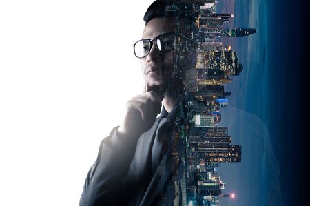 The double exposure image of the businessman thinking overlay with cityscape image and futuristic hologram. The concept of modern life, business, city life and internet of things.の写真素材