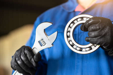 the abstract image of the technician maturing the ball bearing in the industrial factory. the concept of clean energy, futuristic, industrial4.0 and internet of things.の写真素材