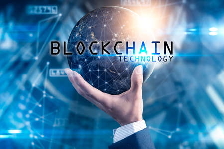 The abstract image of the hand holding the blockchain hologram on hand and element of this image...