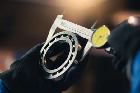 the abstract image of the technician maturing the ball bearing in the industrial factory. the concept of clean energy, futuristic, industrial4.0 and internet of things.の写真素材