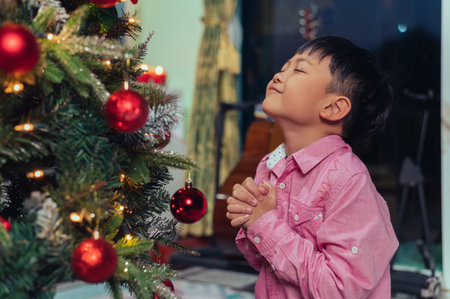 the children playing around the Christmas tree during christmas eve night. the concept of festival, Christmas, new year, celebration and joyfulの写真素材