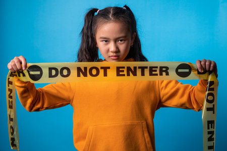 the studio portrait image of the girl showing "do not enter" signの写真素材