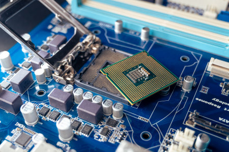 the technician installs the CPU in the computer motherboardの写真素材