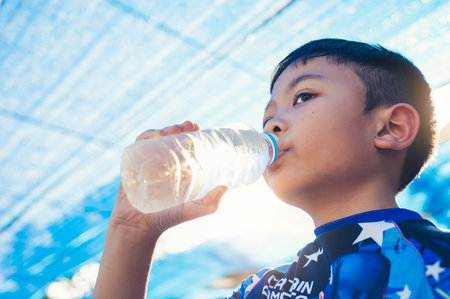 the boy drinking waterの写真素材