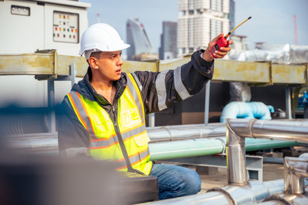 The image captures a skilled engineer inspecting a network of pipelines in a petrochemical facility....