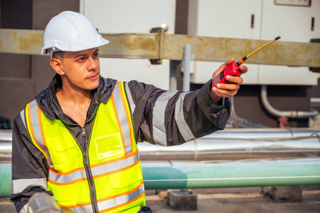 The image captures a skilled engineer inspecting a network of pipelines in a petrochemical facility....
