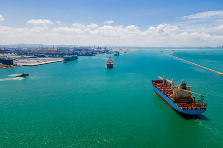 the image provides a stunning aerial view of a bustling cargo ship port, where massive vessels dock and unload their precious cargo.の写真素材
