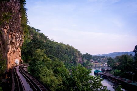 Railroad tracks through a forest, mountain and countryside, Thailand.のeditorial素材