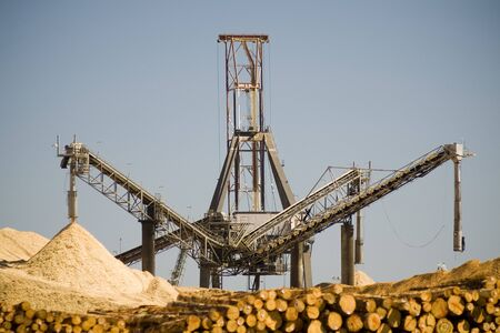 Large timber yards and processing machines on shorefrontの写真素材