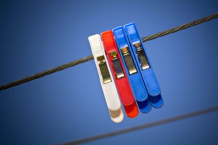 Generic pegs on a washing line in clear blue skyの写真素材