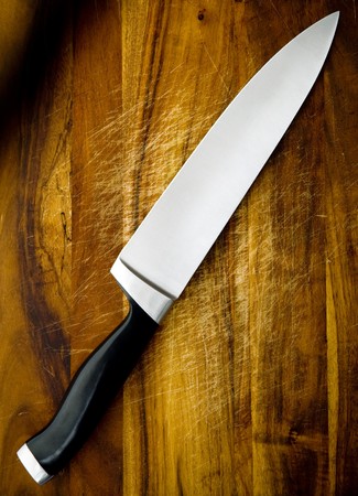 Large chef's knife on wooden chopping boardの写真素材
