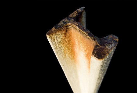 End of a large girder rusted and coloured against blackの写真素材