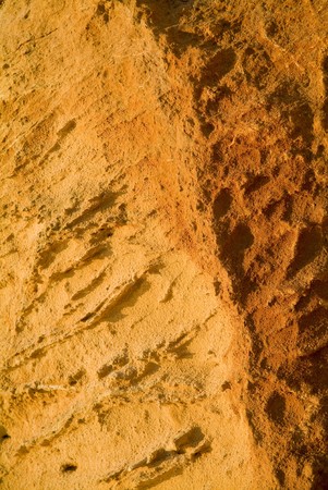 Texture and patterns on a red cliff at sunsetの写真素材