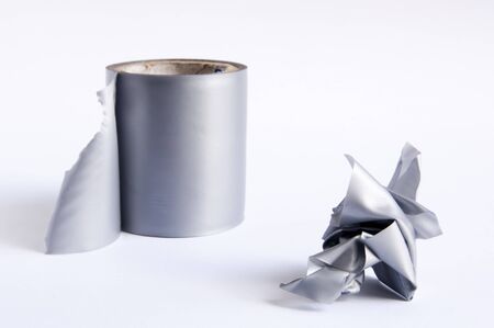 Roll of duct tape with torn off section in a rough ballの写真素材