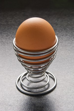 Eggs in modern spiral metal egg cup on bench topの写真素材