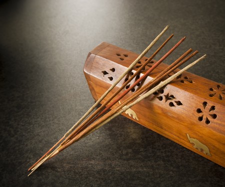 Incense sticks against a timber boxの写真素材