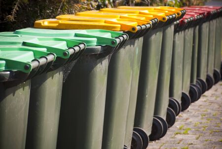 Row of large green wheelie bins for rubbishの写真素材