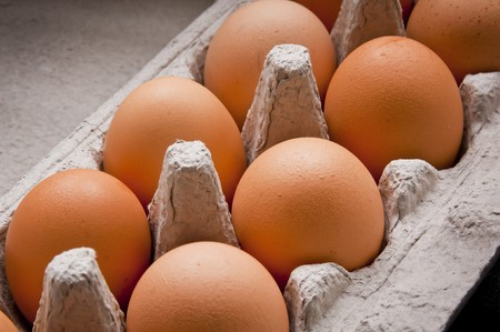 Carton of eggs close up on a bench top