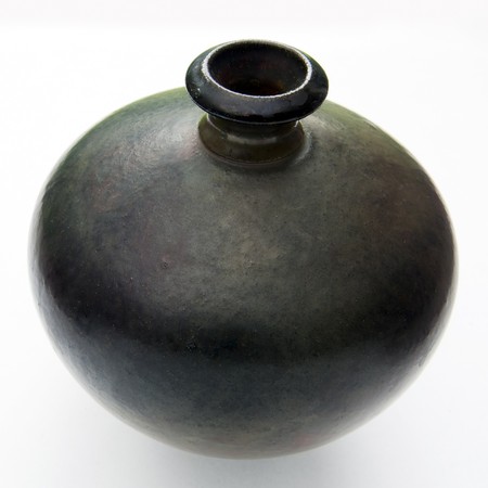 An older style round vase in dark shades on whiteの写真素材