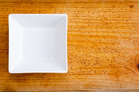 An empty square white bowl on timberの写真素材