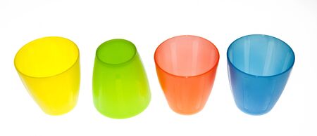 Group of brightly coloured plastic cupsの写真素材