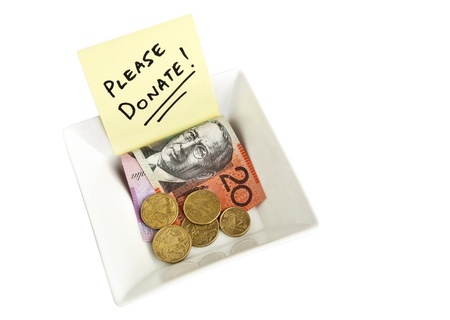 A white bowl with a note asking people to Please Donateの写真素材