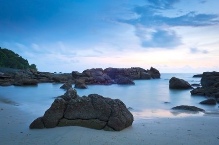 Time-lapse of beach at dusk with rocksの写真素材