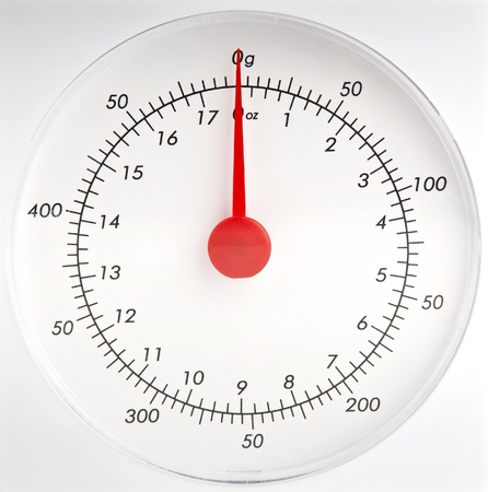White kitchen scale dial with a red pointerの写真素材