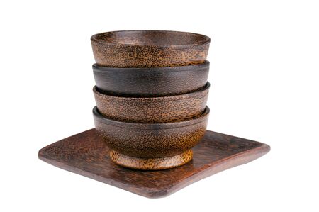 Exotic wooden bowls in a stack isolated over whiteの写真素材