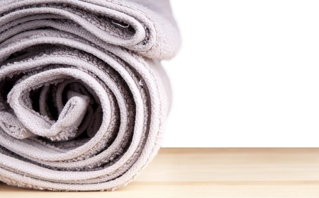Freshly washed rolled towels isolated on whiteの写真素材