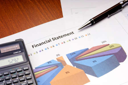 Graphs, calculator and paper statements for finance conceptの写真素材