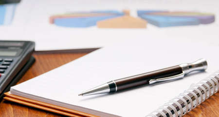Office desk concept with pad, pen, calculator in viewの写真素材