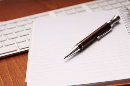 Office desk concept with pad, pen, calculator in viewの写真素材