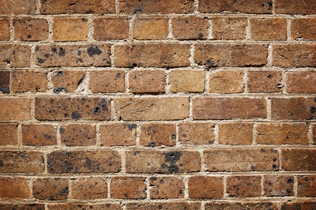 Brick wall in old red bricks in bad condition