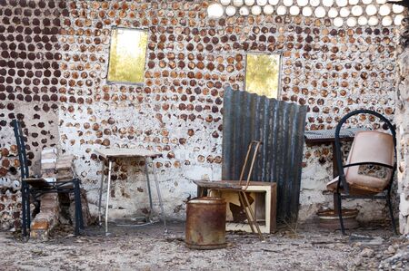 Interior of an old home built from tin cans with old furnitureの写真素材