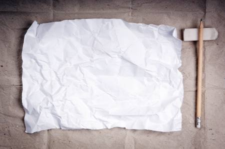 Writing concept - crumpled up paper wads with a sheet of white paper and pencilの写真素材
