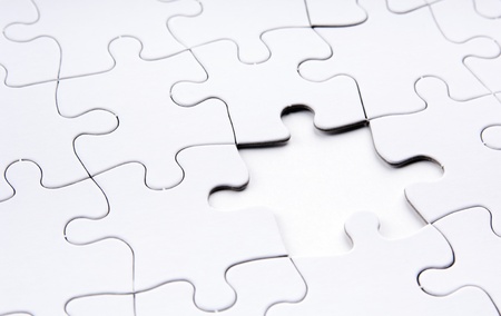 Jigsaw puzzle in white with a missing piece の写真素材