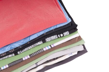 T-Shirts folded and stacked in variety of colors isolated on white