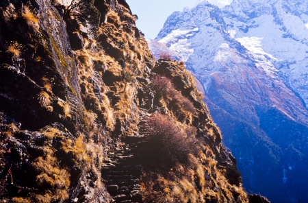 Trekking up steep steps on a cliff edge on the way to Mount Everest Base Camp, Nepal Himalayaの写真素材