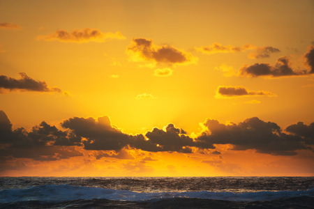 Bright orange sunrise over the ocean off Stradbroke Island, Queensland Australiaの写真素材