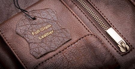 Leather tag with Full Grain Leather text embossed in goldの写真素材