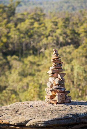 Pile of stones in perfect balance in shallow focus with natural backgroundの写真素材