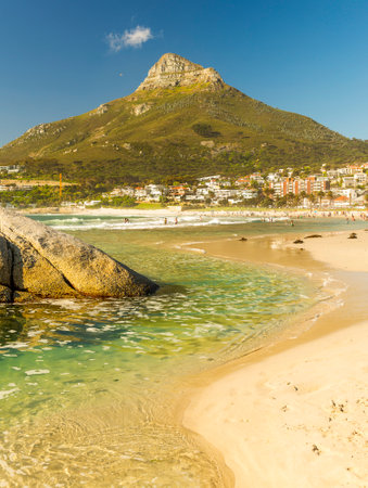 CAMPS BAY, SOUTH AFRICA - 5 OCTOBER 2015: Unidentified people on Camps Bay beach in Cape Town, South Africa, with Signal Hill in view.のeditorial素材
