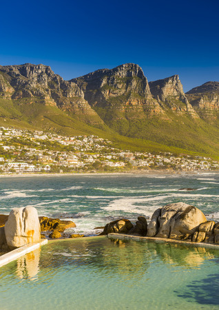 Camps Bay ocean pool with Twelve Apostles behindの写真素材