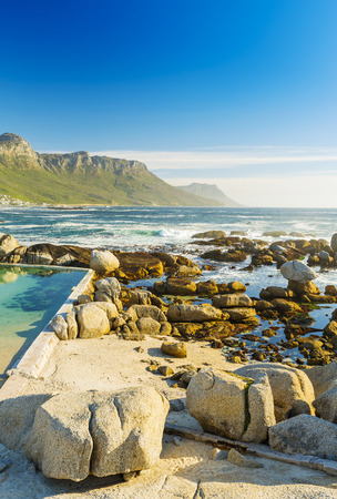 Camps Bay ocean rocks with Twelve Apostles behindの写真素材