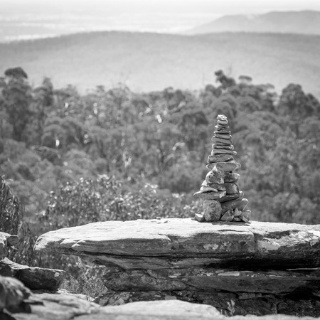 Pile of stones in perfect balance in shallow focus with natural background in black and whiteの写真素材
