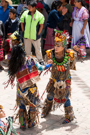 SAN JUAN OSTUNCALCO, GUATEMALA - JUNE 24: Traditional dance done by locals with elaborate costumes and masks at the San Juan Ostuncalco fair in honor of Saint John the Baptist on June 24, 2017 in Guatemala.のeditorial素材