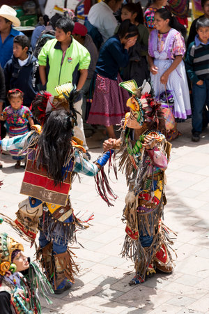 SAN JUAN OSTUNCALCO, GUATEMALA - JUNE 24: Traditional dance done by locals with elaborate costumes and masks at the San Juan Ostuncalco fair in honor of Saint John the Baptist on June 24, 2017 in Guatemala.のeditorial素材