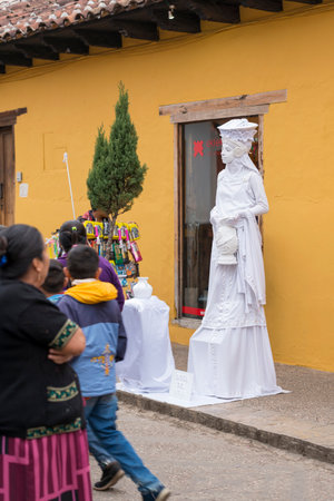 SAN CRISTOBAL, MEXICO - NOVEMBER 27: Unidentified street performer on a street with locals and vendors on November 27, 2016 in San Cristobal. San Cristobal de las Casas is a popular tourist destination in the Chiapas state.のeditorial素材