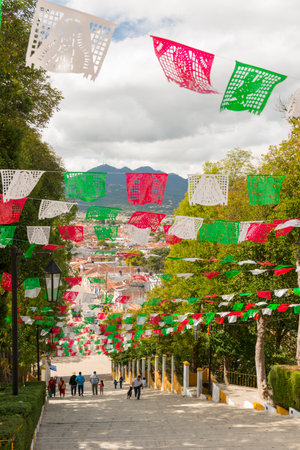 SAN CRISTOBAL, MEXICO - NOVEMBER 28: A view of San Cristobal de las Casas from the steps of the Guadalupe Church with unidentified people under rows of colorful paper flags on November 28, 2016 in San Cristobal. The Guadalupe Church is a popular tourist lのeditorial素材